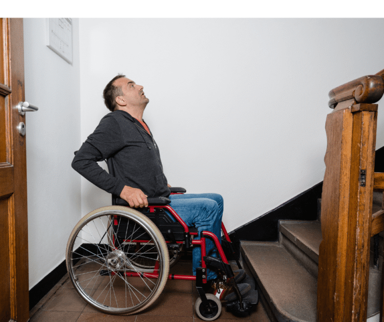 Don’t Be Inaccessible A person in a wheelchair is at the base of a staircase, looking up..